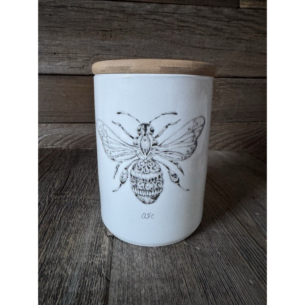 Creative Co-Op White Stoneware Jar With decorative bee and matching bamboo lid